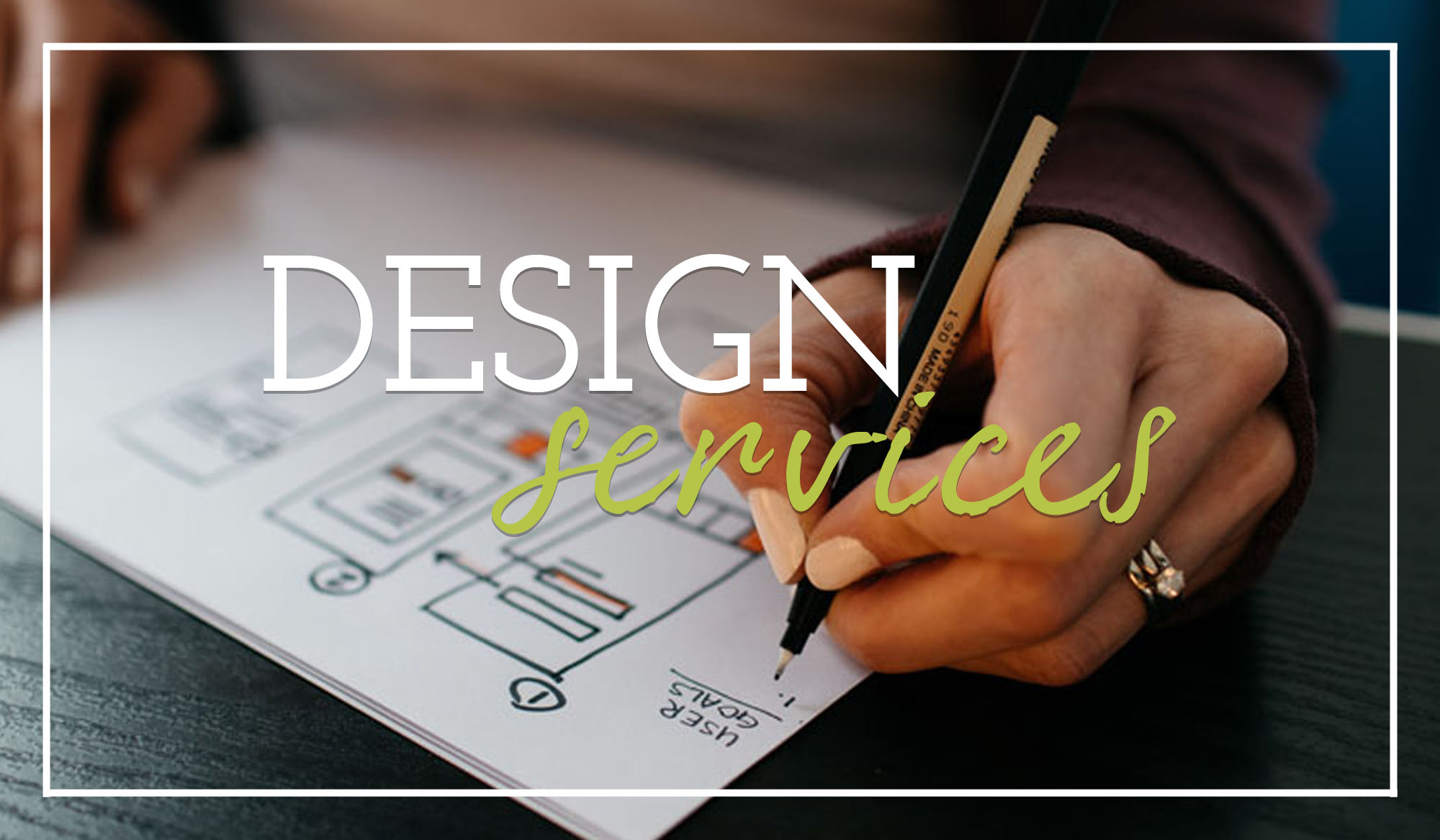 Image that says Design Services over a background of a hand holding a pen drawing a website wireframe